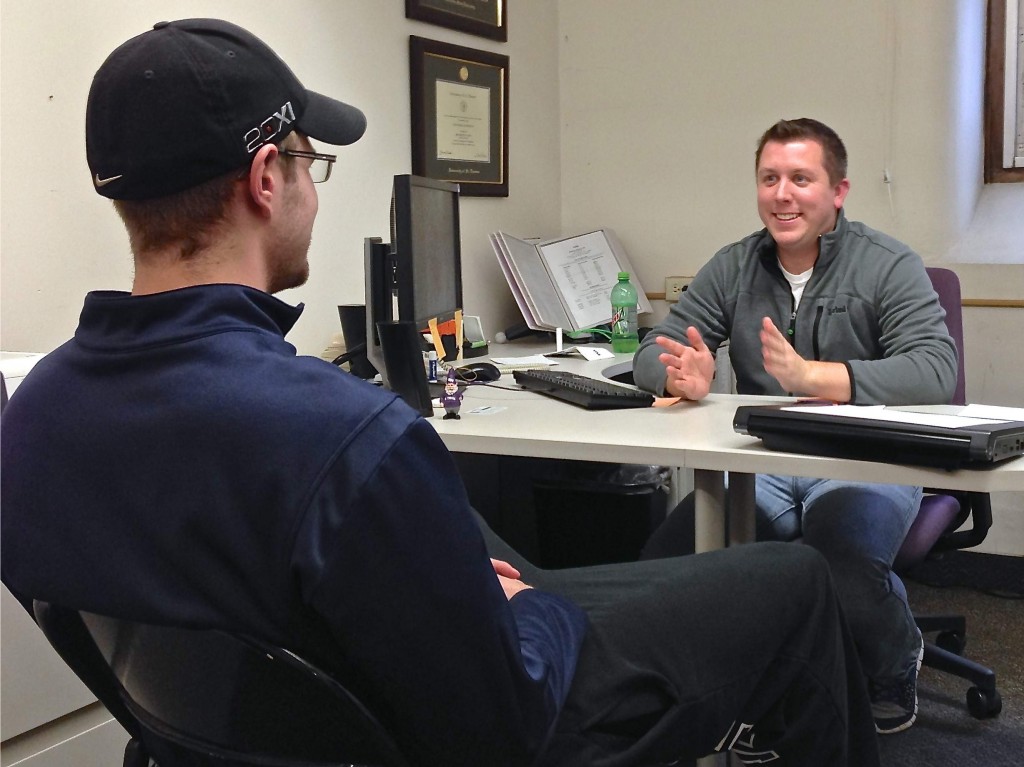 Ireland Hall director Nate Peterson (right) converses with Ireland Hall operations manager Cody Luebeck in his office. Peterson has several meetings and final preparations to complete before his last day at St. Thomas on Friday, Feb. 22. (Zachary Zumbusch/TommieMedia)