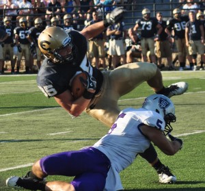 Senior safety Tyler Erstad tackles senior tight end Austin Goetsch. The Tommies will open their season Saturday at home against the Blugolds. (Ali Stinson/TommieMedia) 