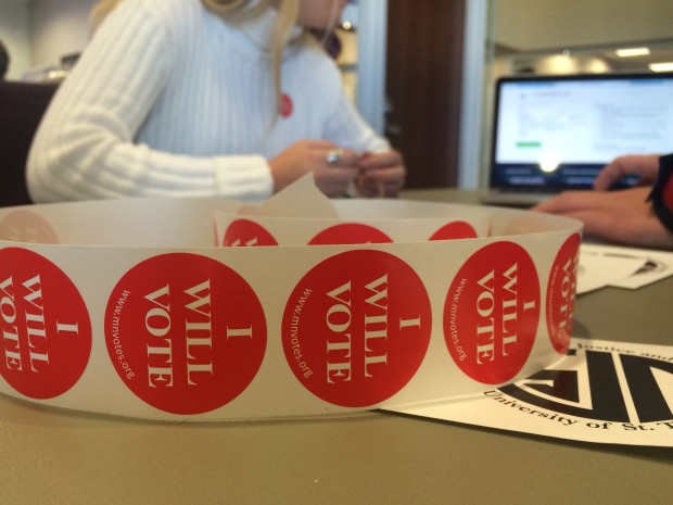 Members of Students for Justice and Peace help their peers register to vote at a table in the Anderson Student Center on Oct. 13. The club was one of the St. Thomas organizations working on the #TommiesVote campaign. (Sophie Carson/TommieMedia) 